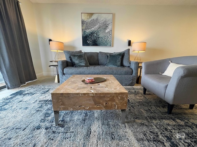 tiled living area featuring baseboards