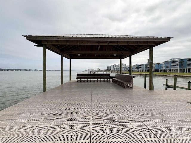 view of dock with a gazebo and a water view