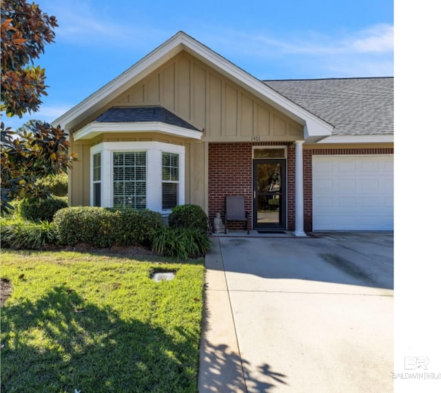 430 W Fort Morgan Rd Unit 1401, Gulf Shores, AL 36542 - view of front of home featuring board and batten siding, brick siding, an attached garage, a shingled roof, and a front yard