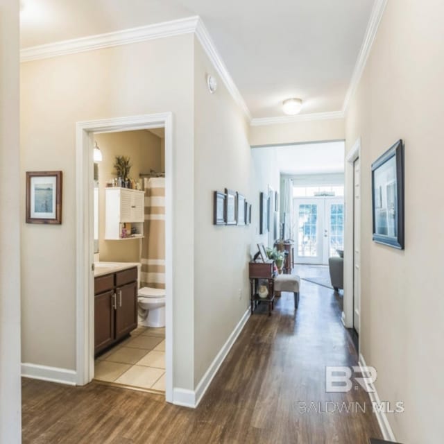 430 W Fort Morgan Rd Unit 1401, Gulf Shores, AL 36542 - hallway with french doors, crown molding, wood finished floors, and baseboards
