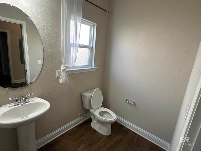 bathroom featuring toilet and hardwood / wood-style floors