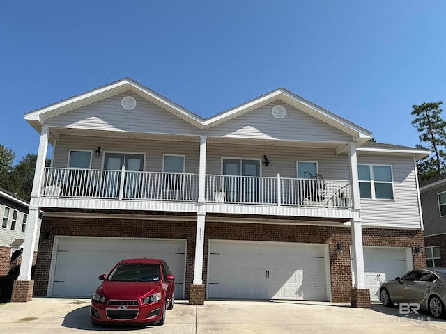 view of front facade featuring a balcony and a garage