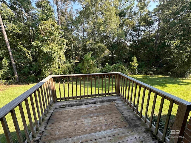 wooden terrace featuring a yard