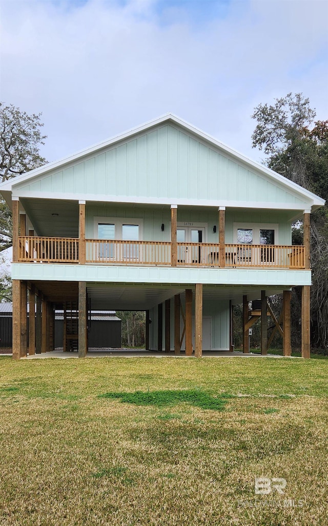 back of house featuring a yard and a jacuzzi