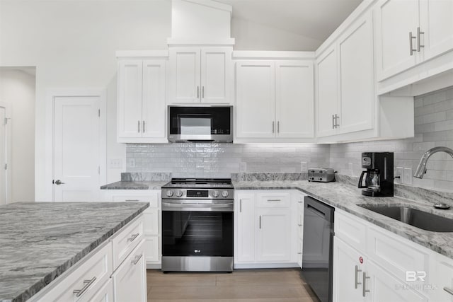 kitchen featuring appliances with stainless steel finishes, a sink, and white cabinets