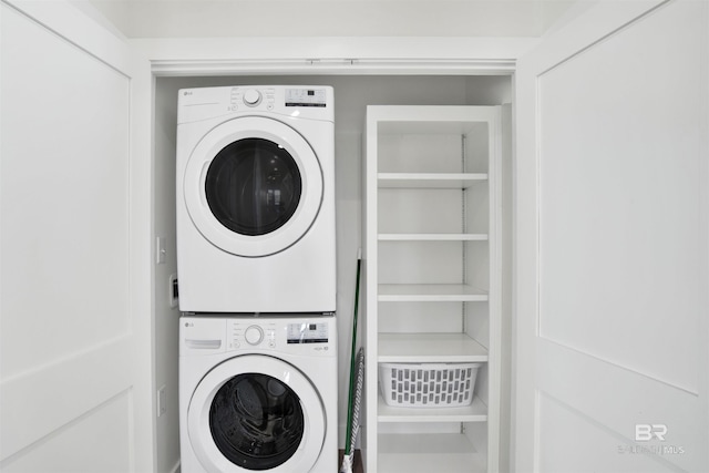 washroom featuring laundry area and stacked washer / dryer