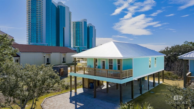 rear view of property with a carport, a view of city, and driveway