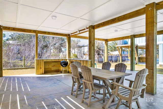 sunroom / solarium with a paneled ceiling