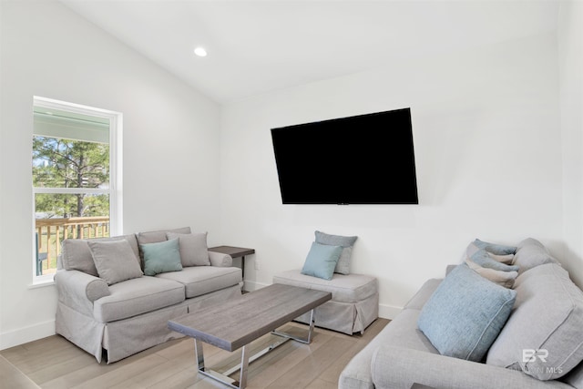 living area with lofted ceiling, light wood-style flooring, baseboards, and recessed lighting