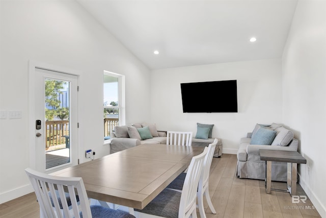 dining space featuring light wood-style flooring, baseboards, vaulted ceiling, and recessed lighting