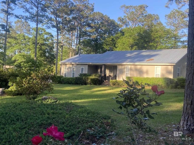 single story home with a front lawn and metal roof
