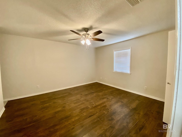 unfurnished room featuring a textured ceiling, visible vents, dark wood-style floors, a ceiling fan, and baseboards