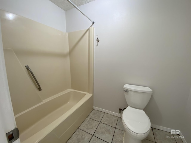 full bathroom with tile patterned flooring, toilet, a textured ceiling, and baseboards