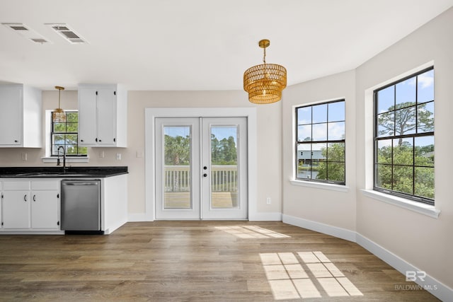 26498 Carondelette Dr, Orange Beach, AL 36561 - kitchen with dishwasher, a chandelier, dark countertops, and white cabinets