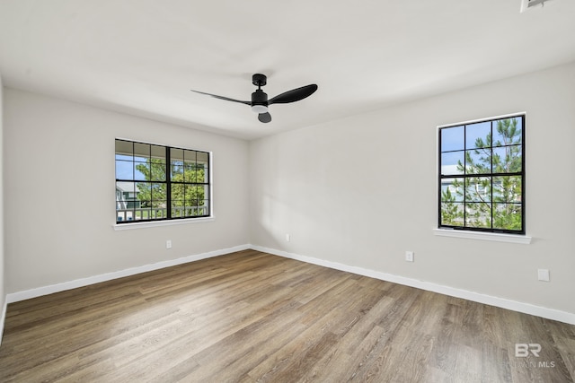 26498 Carondelette Dr, Orange Beach, AL 36561 - unfurnished room with wood finished floors, baseboards, and a ceiling fan