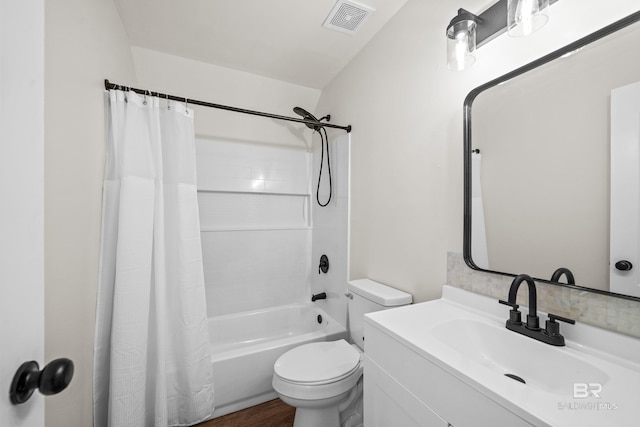 26498 Carondelette Dr, Orange Beach, AL 36561 - bathroom with toilet, shower / bathtub combination with curtain, vanity, and wood finished floors