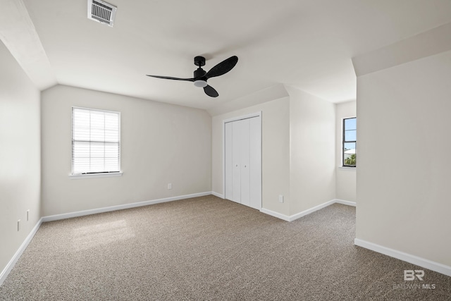 26498 Carondelette Dr, Orange Beach, AL 36561 - unfurnished bedroom with carpet flooring, baseboards, ceiling fan, a closet, and lofted ceiling