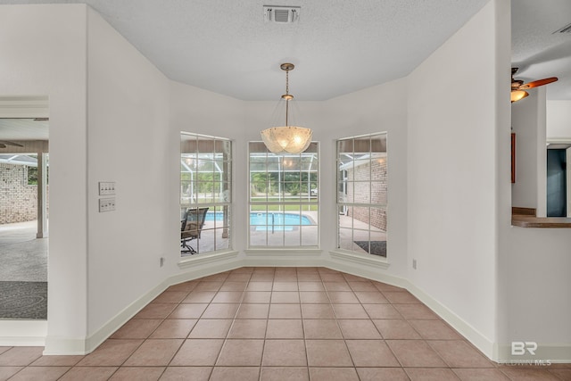 unfurnished dining area featuring visible vents, plenty of natural light, and light tile patterned floors