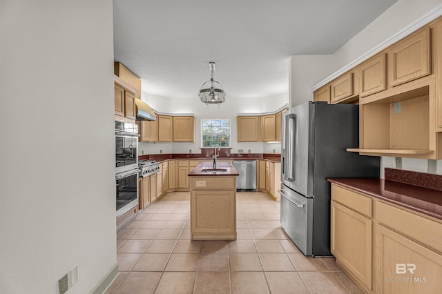 kitchen with a kitchen island, light tile patterned floors, a chandelier, light brown cabinets, and stainless steel appliances