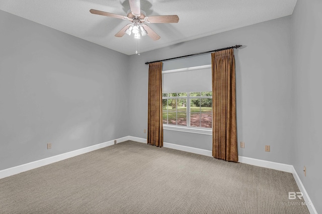 spare room with baseboards, ceiling fan, carpet flooring, and a textured ceiling