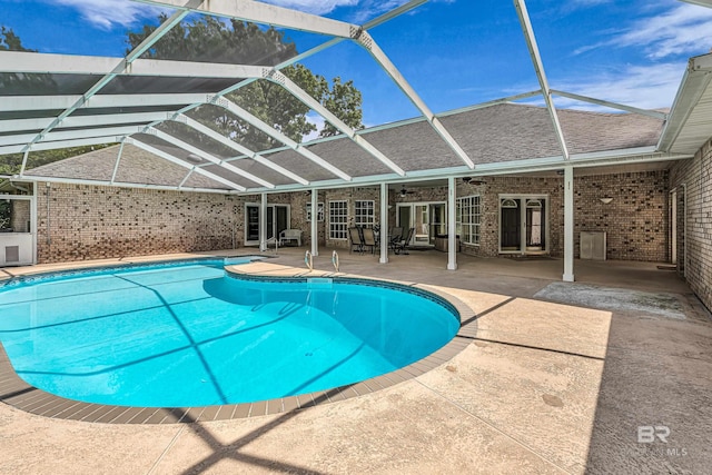 pool featuring french doors, a patio, ceiling fan, and glass enclosure
