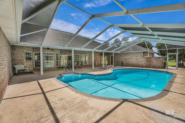 pool with a lanai, a patio, and ceiling fan