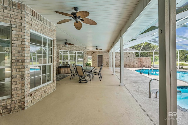 view of patio / terrace with glass enclosure, a fenced in pool, a ceiling fan, and outdoor dining space