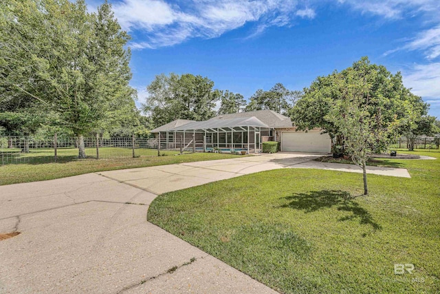 view of front facade with fence, a garage, a front yard, a lanai, and driveway