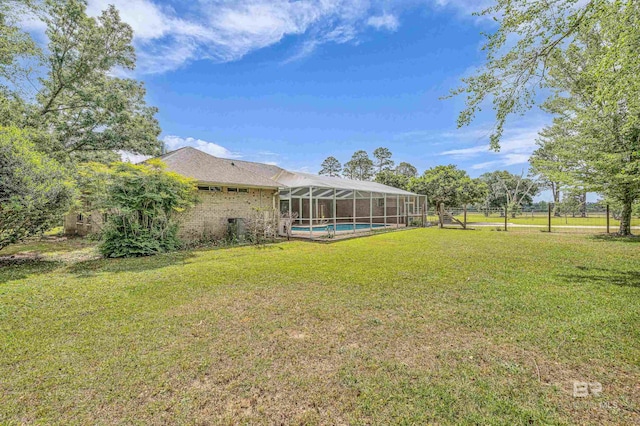 view of yard featuring a lanai and an outdoor pool