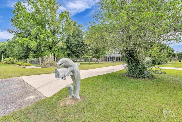 exterior space featuring fence and driveway
