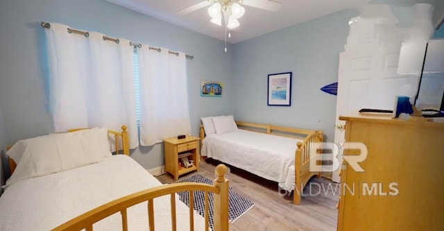 bedroom with light hardwood / wood-style flooring and ceiling fan