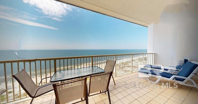 balcony featuring a water view and a beach view