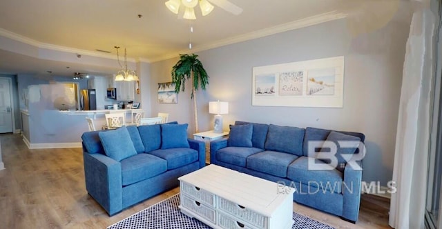 living room with ceiling fan, light wood-type flooring, and crown molding