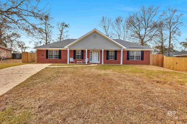 ranch-style house featuring a porch and a front yard