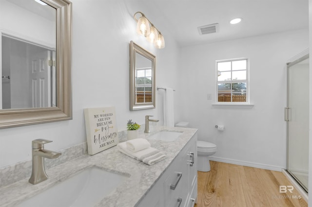 bathroom featuring hardwood / wood-style flooring, vanity, and toilet