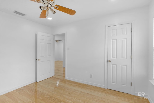 unfurnished bedroom with ceiling fan and light wood-type flooring