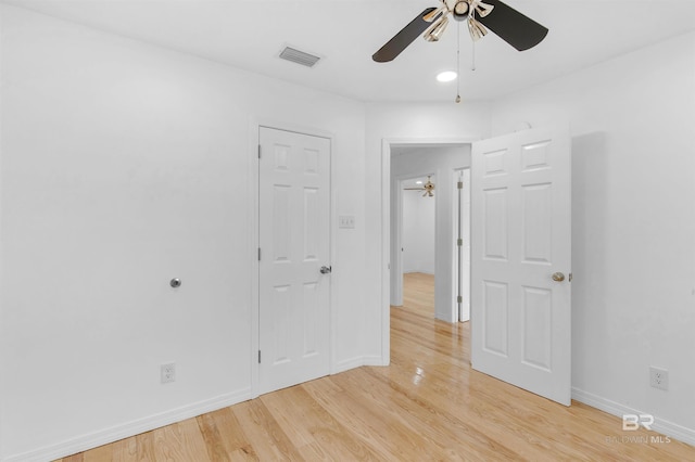 spare room with ceiling fan and light wood-type flooring