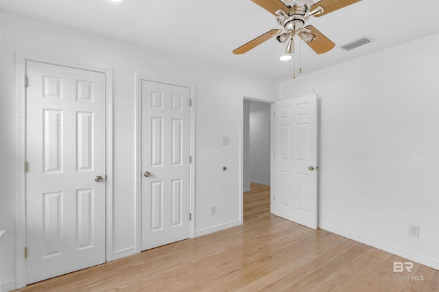 unfurnished bedroom featuring ceiling fan and light wood-type flooring