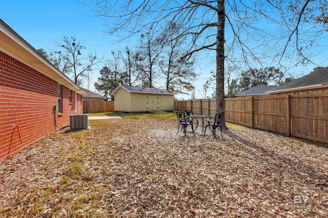 view of yard featuring a shed and central air condition unit