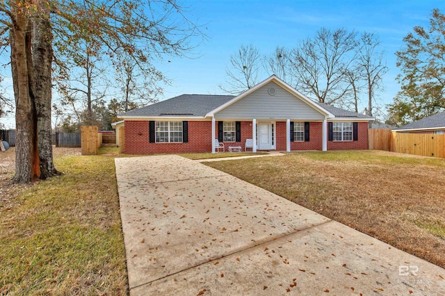 single story home with a front yard and covered porch