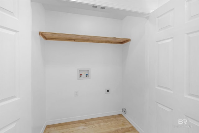 clothes washing area featuring electric dryer hookup, washer hookup, and light wood-type flooring