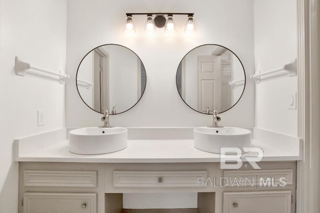 bathroom with double vanity and a sink