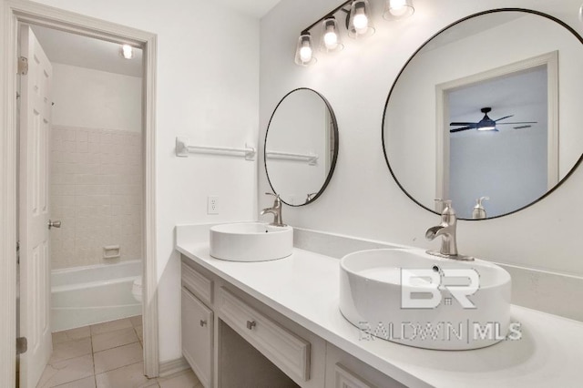 full bathroom featuring tile patterned floors, tub / shower combination, a sink, and double vanity