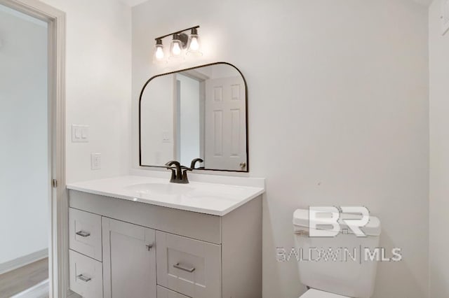 bathroom featuring vanity and toilet