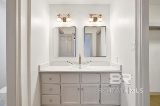 bathroom featuring toilet and vanity