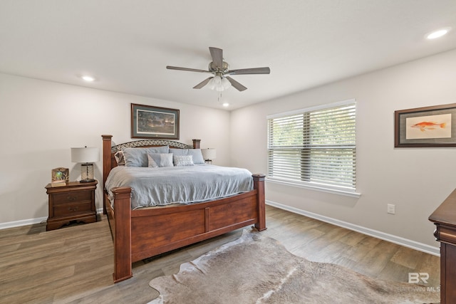 bedroom with ceiling fan and light hardwood / wood-style floors