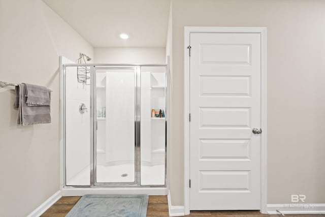 bathroom featuring hardwood / wood-style floors and an enclosed shower