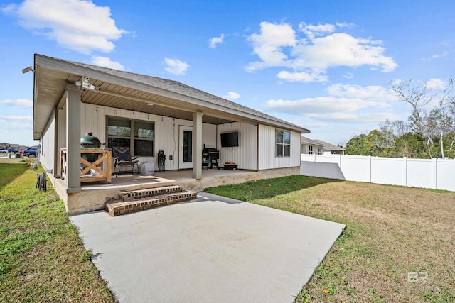 back of property featuring a yard and a patio area