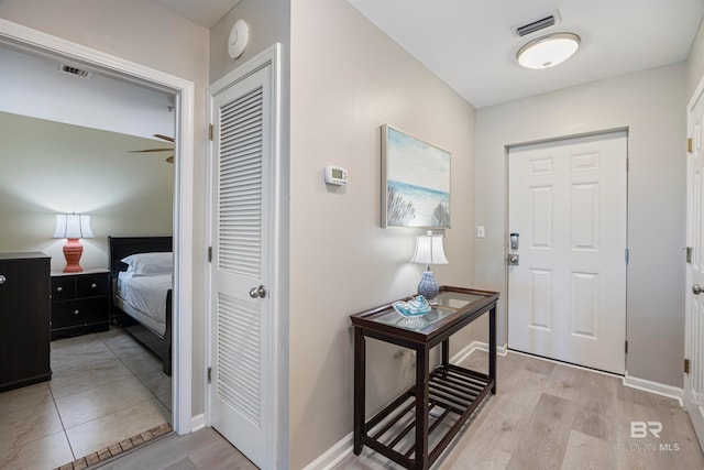 foyer entrance with light hardwood / wood-style floors and ceiling fan