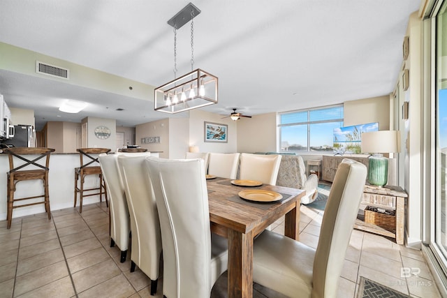 dining room featuring light tile patterned floors, visible vents, and ceiling fan